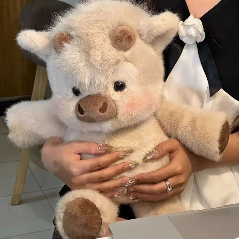 Person holding a plush cow toy with a blurred background