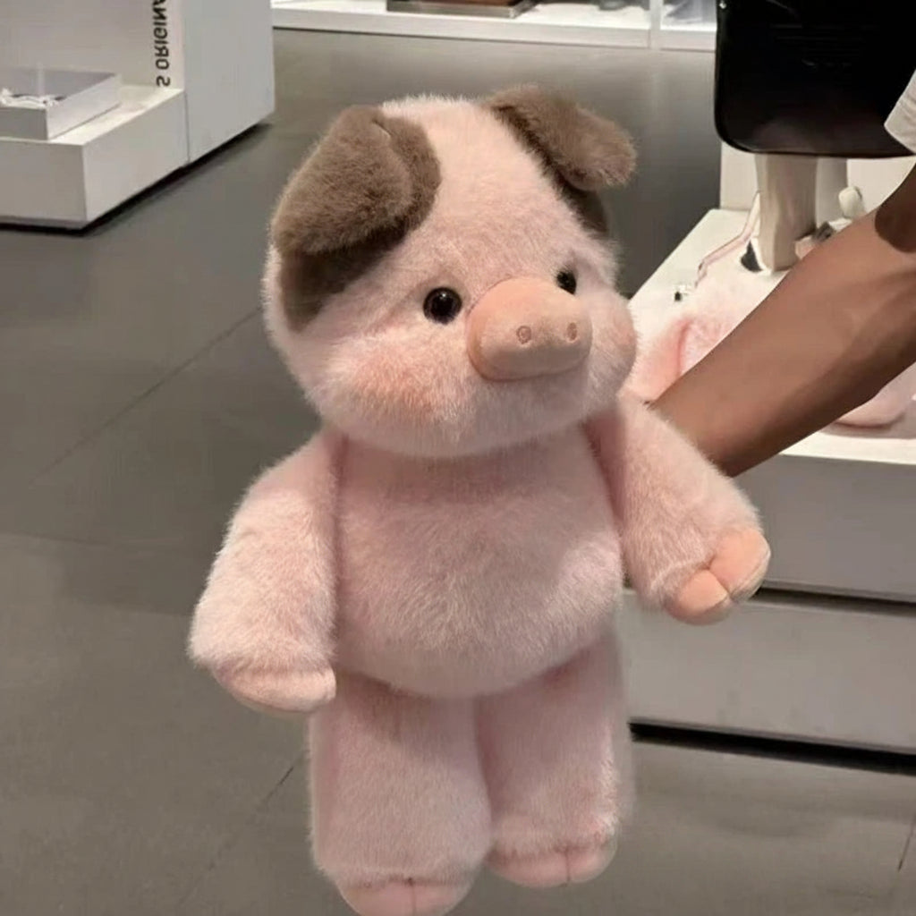 Pink plush pig toy held by a person in an indoor setting