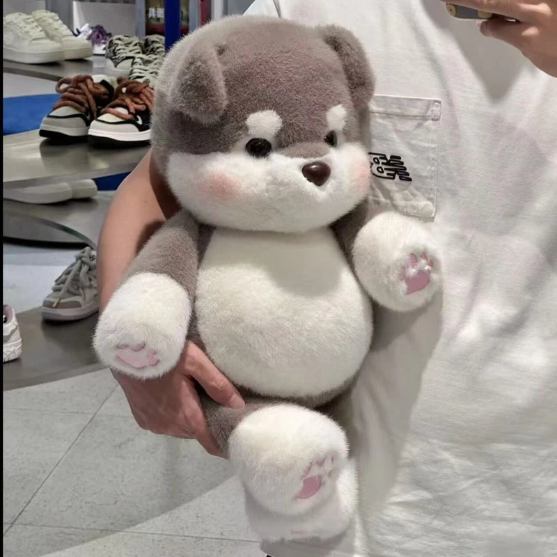 Person holding a plush toy dog