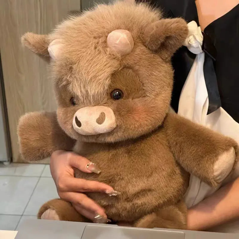 Person holding a cow plush with a neutral background