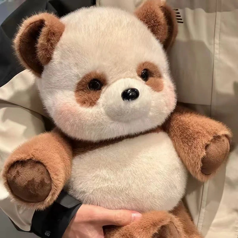Plush Brown panda held by a person with a neutral background