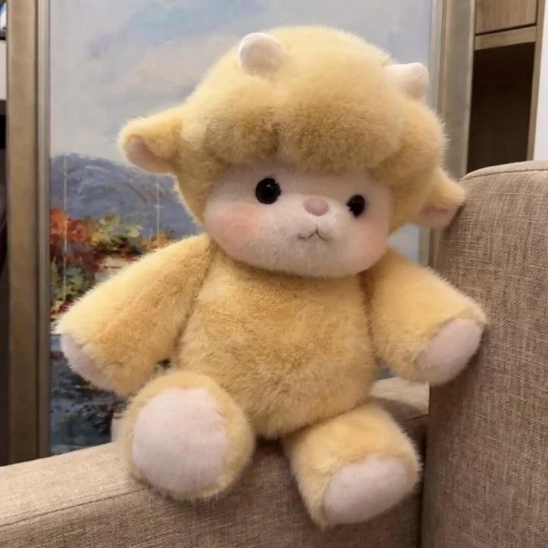 Yellow plush toy sheep sitting on a couch.