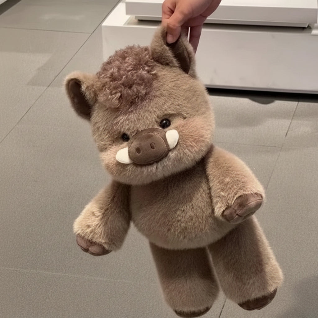 Plush toy hog held by a hand on a tiled floor